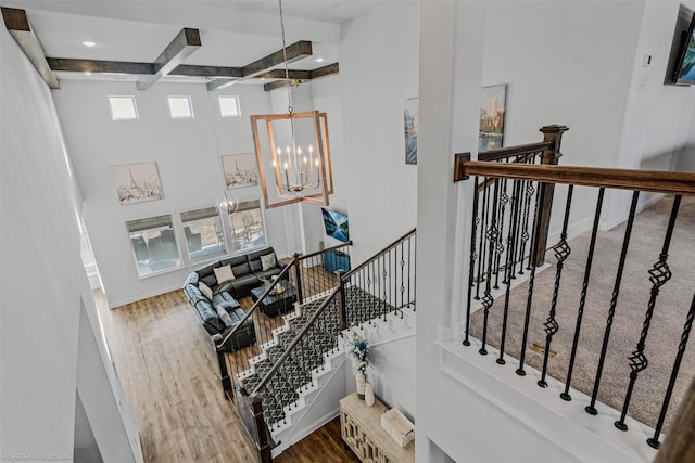 2010 Topaz Dr, Rockwall, TX 75087 - staircase with wood finished floors, beam ceiling, a chandelier, coffered ceiling, and recessed lighting