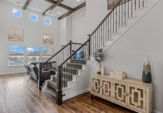 2010 Topaz Dr, Rockwall, TX 75087 - stairs with a towering ceiling, wood finished floors, beam ceiling, a chandelier, and coffered ceiling