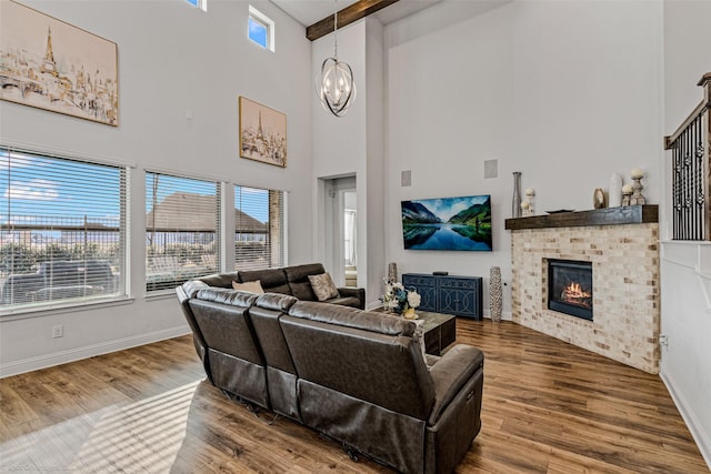 2010 Topaz Dr, Rockwall, TX 75087 - living room with a towering ceiling, a chandelier, wood finished floors, and a fireplace
