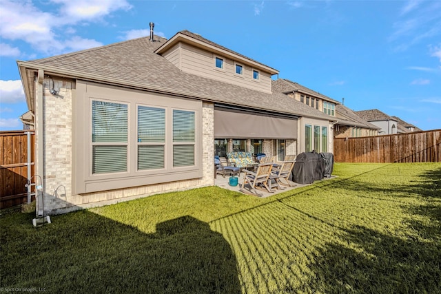2010 Topaz Dr, Rockwall, TX 75087 - back of property with a shingled roof, a patio area, and brick siding
