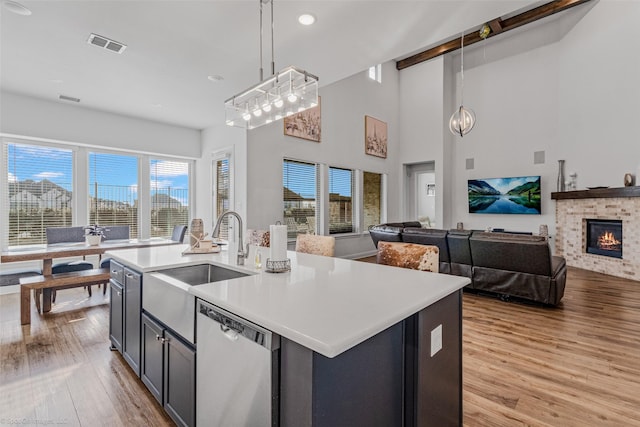 2010 Topaz Dr, Rockwall, TX 75087 - kitchen featuring dishwasher, light wood-style floors, healthy amount of natural light, a center island with sink, and recessed lighting