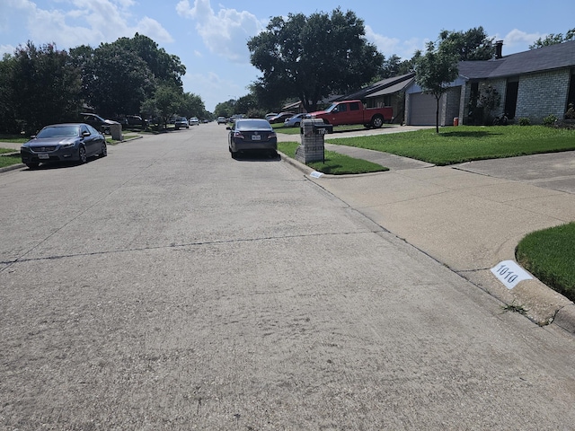 1010 California Trl, Grand Prairie, TX 75052 - view of concrete road featuring curbs and sidewalks