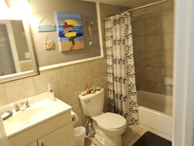 1010 California Trl, Grand Prairie, TX 75052 - bathroom featuring vanity, shower / bath combo, tile patterned flooring, tile walls, and wainscoting