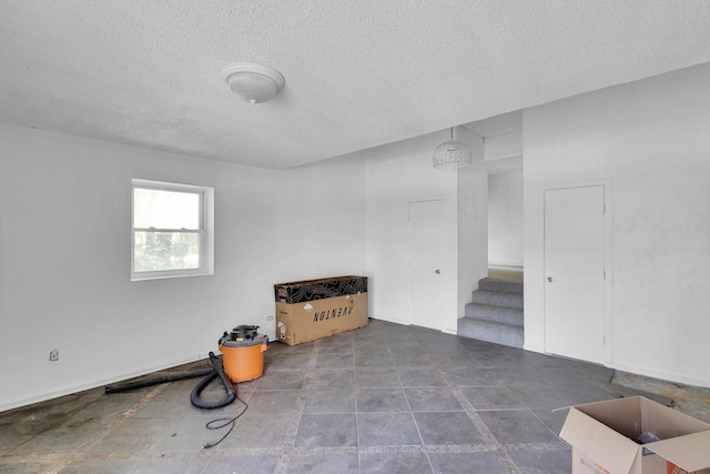 5201 Ranchero Ln, Dallas, TX 75236 - empty room featuring a textured ceiling and stairs