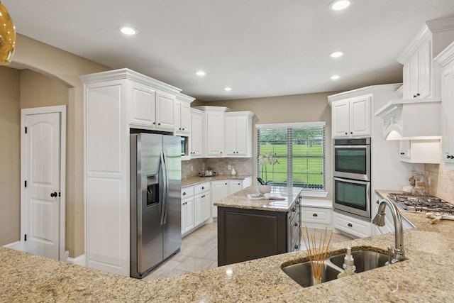 320 Tate Cir, Sherman, TX 75090 - kitchen featuring stainless steel appliances, decorative backsplash, white cabinetry, and recessed lighting