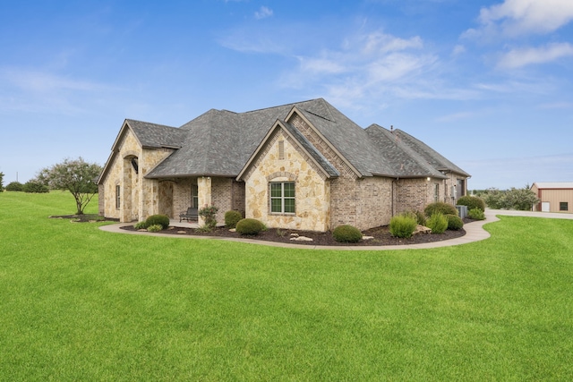 320 Tate Cir, Sherman, TX 75090 - french provincial home with stone siding, a front lawn, and a shingled roof