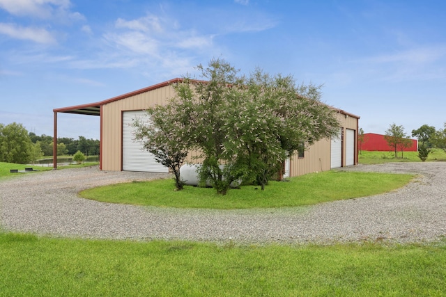 320 Tate Cir, Sherman, TX 75090 - view of home's exterior with a detached garage, gravel driveway, and an outbuilding