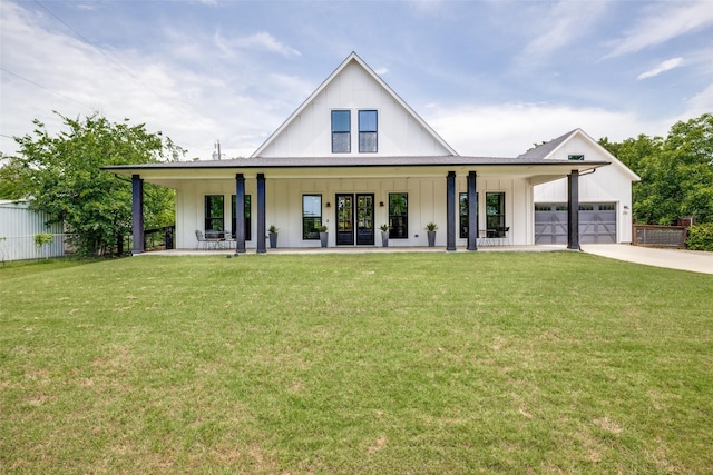 310 Oak Dr, Argyle, TX 76226 - view of front of house with board and batten siding, driveway, a garage, and a porch
