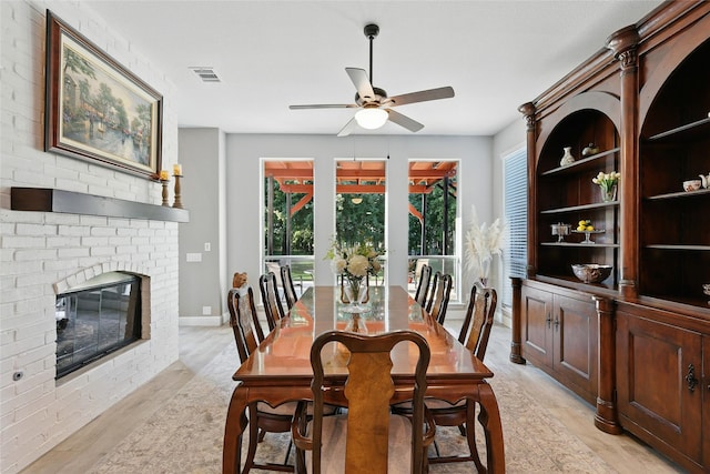 730 Emerald Sound Blvd, Oak Point, TX 75068 - dining area with a ceiling fan, light wood-style floors, and a fireplace