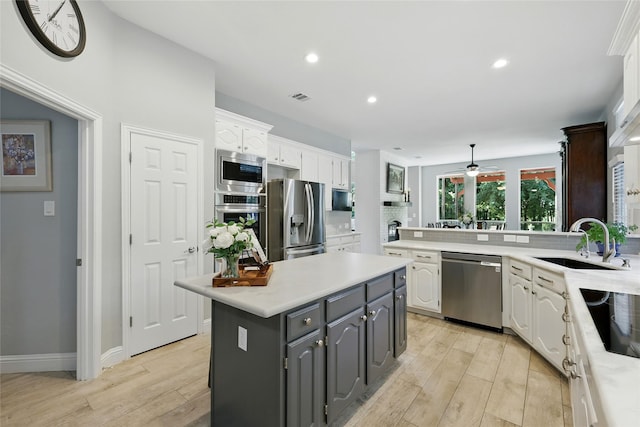 730 Emerald Sound Blvd, Oak Point, TX 75068 - kitchen with appliances with stainless steel finishes, white cabinetry, light wood-style floors, light countertops, and recessed lighting