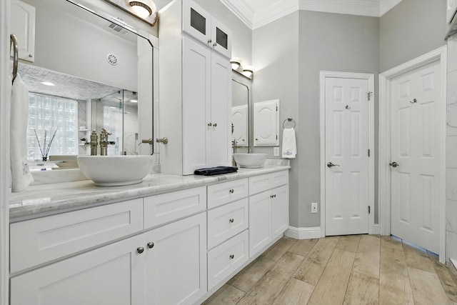 730 Emerald Sound Blvd, Oak Point, TX 75068 - bathroom featuring crown molding, double vanity, wood finished floors, and a shower with shower door