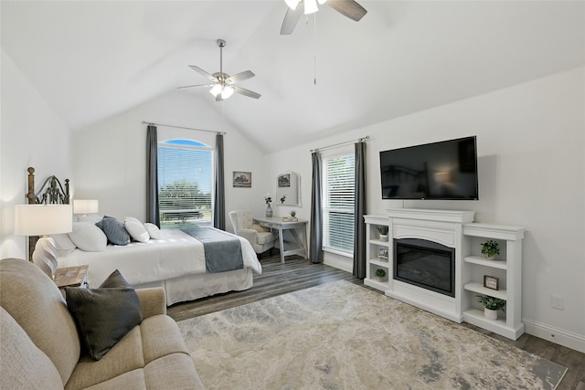 730 Emerald Sound Blvd, Oak Point, TX 75068 - bedroom featuring wood finished floors, multiple windows, lofted ceiling, a ceiling fan, and a glass covered fireplace