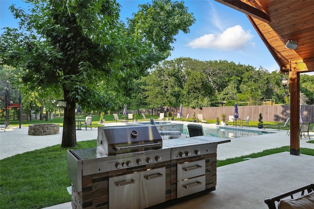 730 Emerald Sound Blvd, Oak Point, TX 75068 - view of patio / terrace featuring exterior kitchen and a fire pit