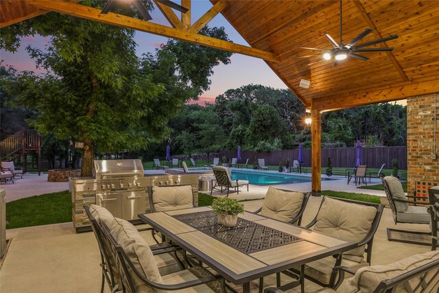730 Emerald Sound Blvd, Oak Point, TX 75068 - patio terrace at dusk featuring exterior kitchen, outdoor dining space, a patio, and a ceiling fan