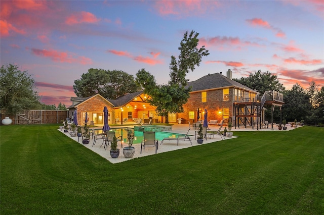 730 Emerald Sound Blvd, Oak Point, TX 75068 - back of house at dusk with a patio, a chimney, a wooden deck, and brick siding