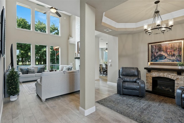 730 Emerald Sound Blvd, Oak Point, TX 75068 - living room with ceiling fan, light wood-style flooring, a fireplace, crown molding, and a chandelier