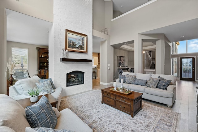 730 Emerald Sound Blvd, Oak Point, TX 75068 - living room with plenty of natural light, a towering ceiling, a brick fireplace, and wood finished floors