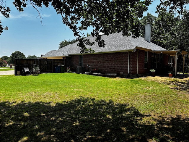 100 Palomino Ct, Shady Shores, TX 76208 - back of property featuring a chimney, a yard, brick siding, and roof with shingles