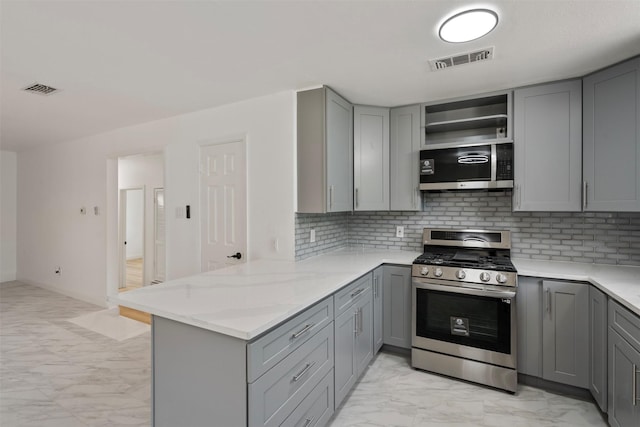 1228 Brookside Dr, Hurst, TX 76053 - kitchen with stainless steel appliances, gray cabinets, and light marble finish floors