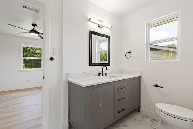 1228 Brookside Dr, Hurst, TX 76053 - bathroom featuring vanity, ceiling fan, and marble finish flooring