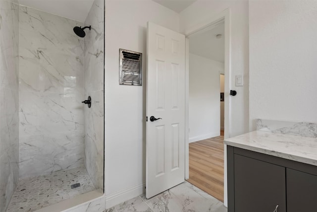 1228 Brookside Dr, Hurst, TX 76053 - bathroom featuring a marble finish shower, marble look tile flooring, and vanity