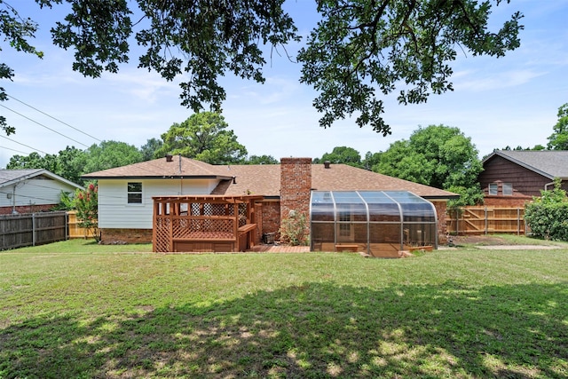 1228 Brookside Dr, Hurst, TX 76053 - rear view of property featuring a fenced backyard, a chimney, roof with shingles, a sunroom, and a wooden deck