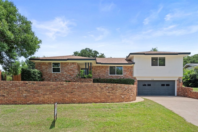 1228 Brookside Dr, Hurst, TX 76053 - split level home featuring a garage, concrete driveway, a front yard, and brick siding