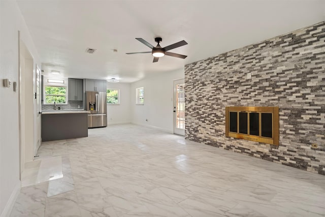 1228 Brookside Dr, Hurst, TX 76053 - unfurnished living room featuring light marble finish flooring and ceiling fan