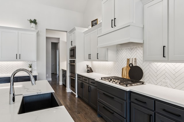 3364 Waverly Dr, Celina, TX 75009 - kitchen featuring stainless steel appliances, white cabinetry, premium range hood, and backsplash