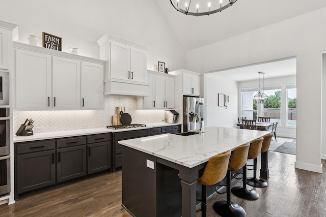 3364 Waverly Dr, Celina, TX 75009 - kitchen with a chandelier, high vaulted ceiling, appliances with stainless steel finishes, decorative backsplash, and hanging light fixtures
