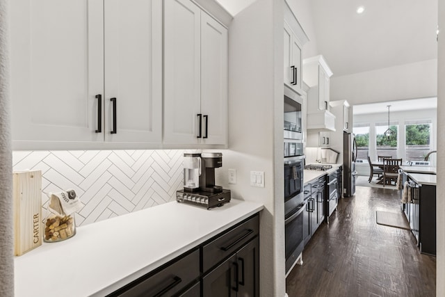 3364 Waverly Dr, Celina, TX 75009 - kitchen with white cabinetry, light countertops, backsplash, stainless steel appliances, and dark wood finished floors