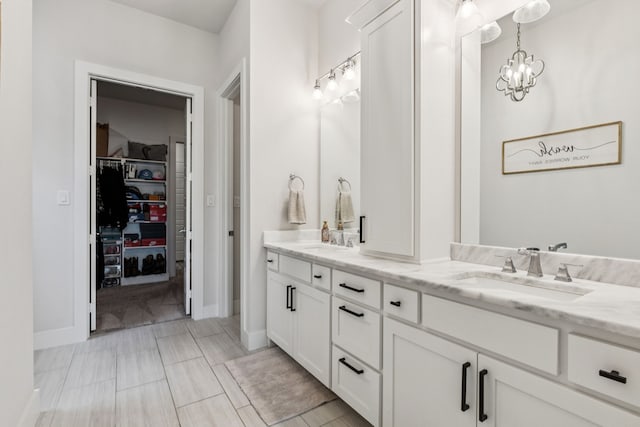 3364 Waverly Dr, Celina, TX 75009 - bathroom with double vanity, a walk in closet, and a chandelier