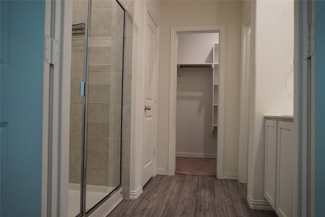 423 Pepperbark Ave, Princeton, TX 75407 - full bathroom featuring a shower stall, wood finished floors, and a walk in closet