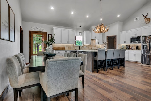 234 Pumphrey Rd, Loving, TX 76460 - dining area featuring a chandelier, lofted ceiling, dark wood-type flooring, and recessed lighting