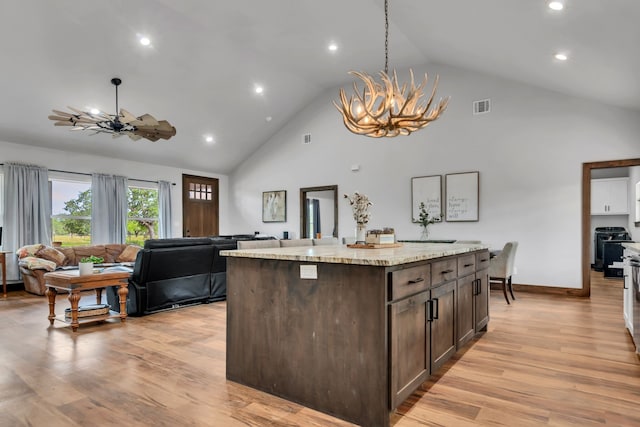234 Pumphrey Rd, Loving, TX 76460 - kitchen with a chandelier, recessed lighting, open floor plan, high vaulted ceiling, and dark brown cabinetry