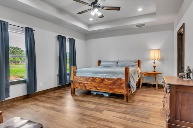 234 Pumphrey Rd, Loving, TX 76460 - bedroom featuring light wood finished floors, a tray ceiling, recessed lighting, and a ceiling fan