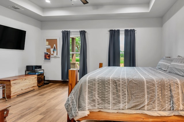 234 Pumphrey Rd, Loving, TX 76460 - bedroom with a tray ceiling, wood finished floors, and a ceiling fan