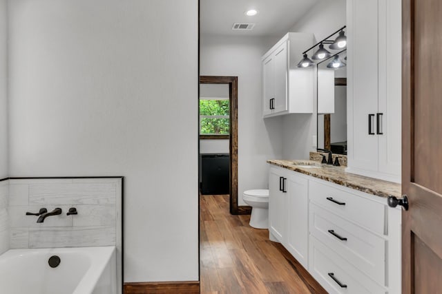 234 Pumphrey Rd, Loving, TX 76460 - full bathroom featuring vanity, a bath, and wood finished floors