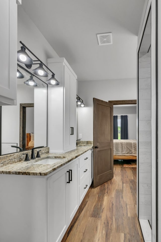 234 Pumphrey Rd, Loving, TX 76460 - bathroom featuring ensuite bath, vanity, and wood finished floors