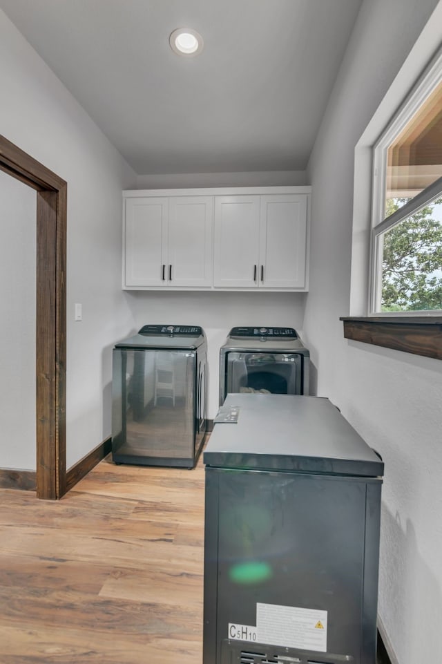 234 Pumphrey Rd, Loving, TX 76460 - laundry room with independent washer and dryer, cabinet space, light wood-style floors, and recessed lighting