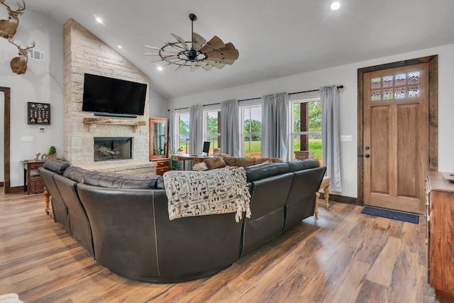 234 Pumphrey Rd, Loving, TX 76460 - living room with wood finished floors, a stone fireplace, a ceiling fan, recessed lighting, and high vaulted ceiling