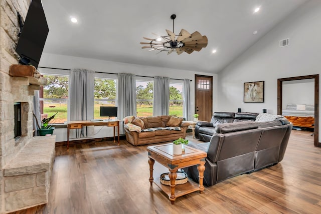 234 Pumphrey Rd, Loving, TX 76460 - living area with wood finished floors, high vaulted ceiling, a stone fireplace, and recessed lighting