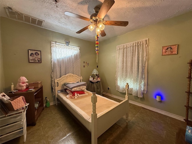 7032 Wofford Ave, Dallas, TX 75227 - bedroom featuring a textured ceiling and ceiling fan