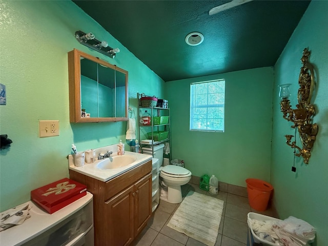 7032 Wofford Ave, Dallas, TX 75227 - bathroom with tile patterned floors, vanity, and lofted ceiling