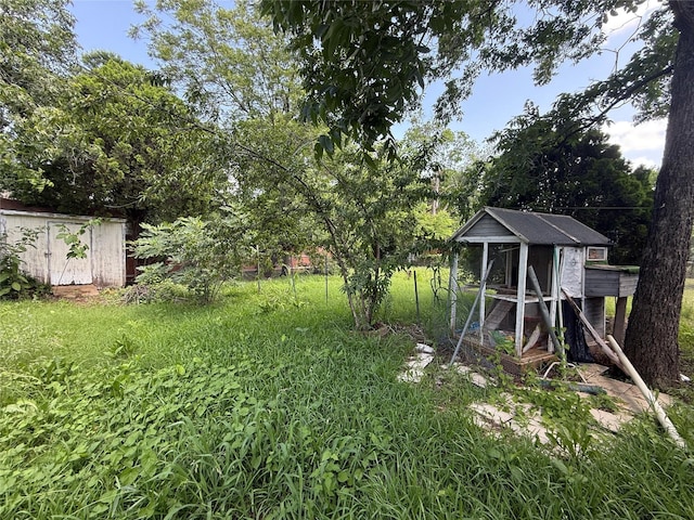 7032 Wofford Ave, Dallas, TX 75227 - view of green lawn featuring exterior structure and a storage unit