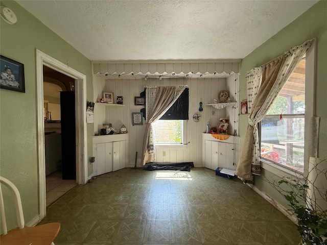 7032 Wofford Ave, Dallas, TX 75227 - empty room with plenty of natural light, a textured ceiling, and a smoke detector