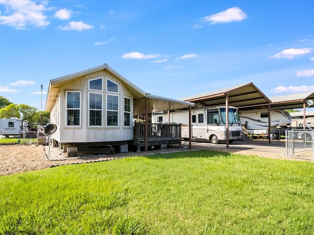 1045 Pelican Isle Dr, Kerens, TX 75144 - rear view of house with a carport and a lawn