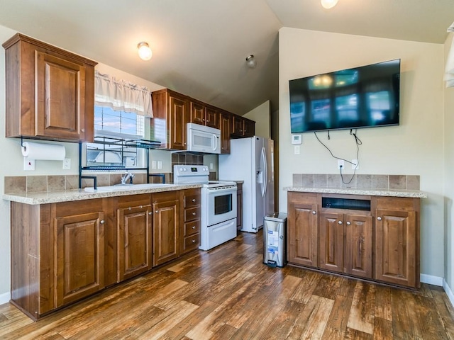 1045 Pelican Isle Dr, Kerens, TX 75144 - kitchen featuring white appliances, dark wood-type flooring, vaulted ceiling, and light stone countertops