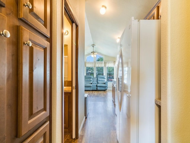 1045 Pelican Isle Dr, Kerens, TX 75144 - corridor with vaulted ceiling, dark wood-style flooring, and a textured wall