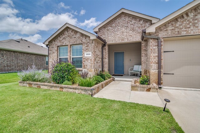 1315 Blessed Ln, Royse City, TX 75189 - view of front of house with a front yard, brick siding, and an attached garage